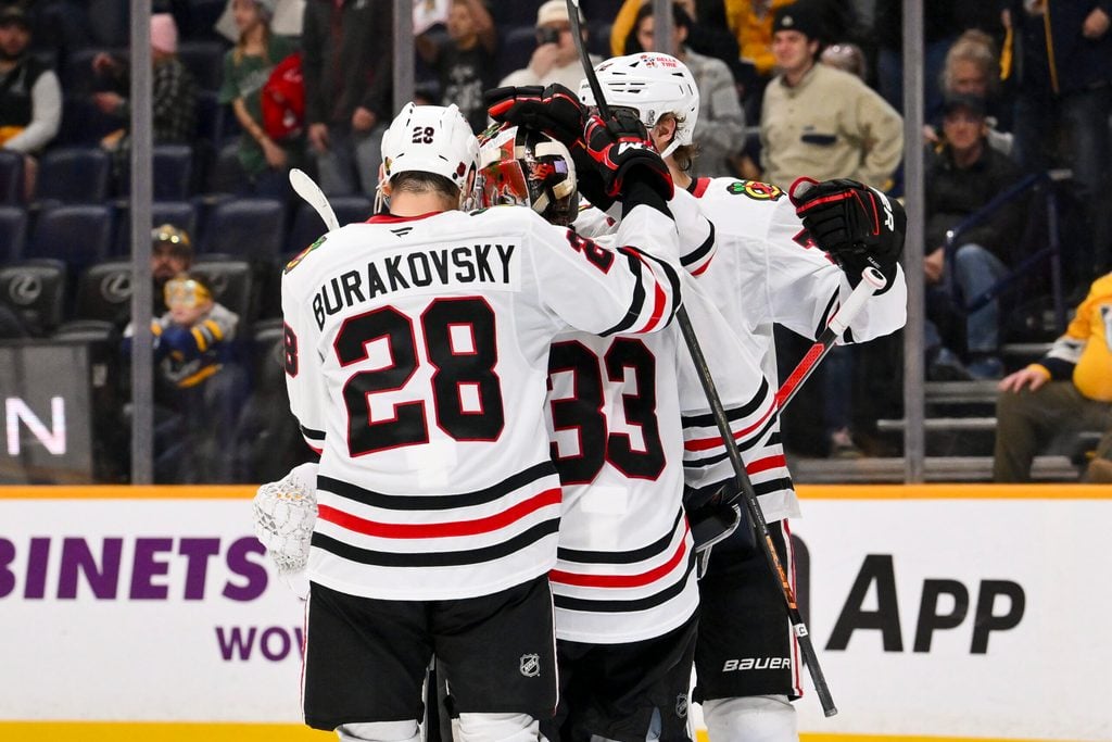 Jan 10, 2026; Nashville, Tennessee, USA; Chicago Blackhawks goaltender Drew Commesso (33) celebrates the win with his teammates against the Nashville Predators during the third period at Bridgestone Arena. Mandatory Credit: Steve Roberts-Imagn Images