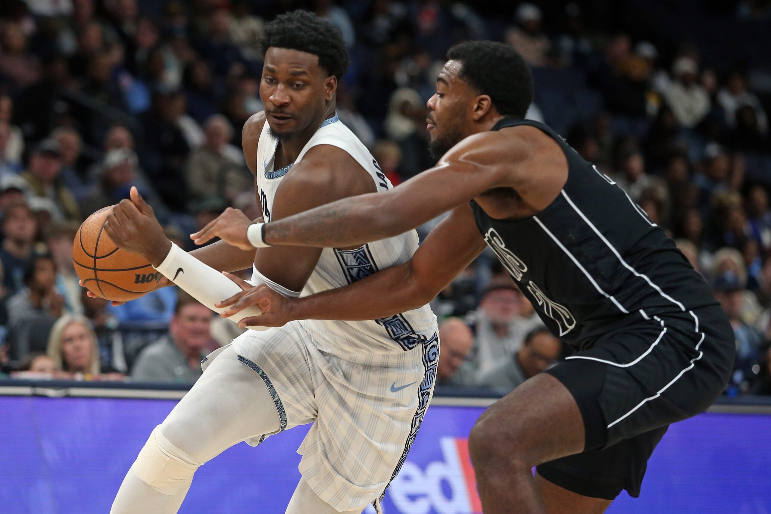 Jan 11, 2026; Memphis, Tennessee, USA; Memphis Grizzlies forward/center Jaren Jackson Jr. (8) drives to the basket as Brooklyn Nets center Day'Ron Sharpe (20) defends during the fourth quarter at FedExForum. Mandatory Credit: Petre Thomas-Imagn Images