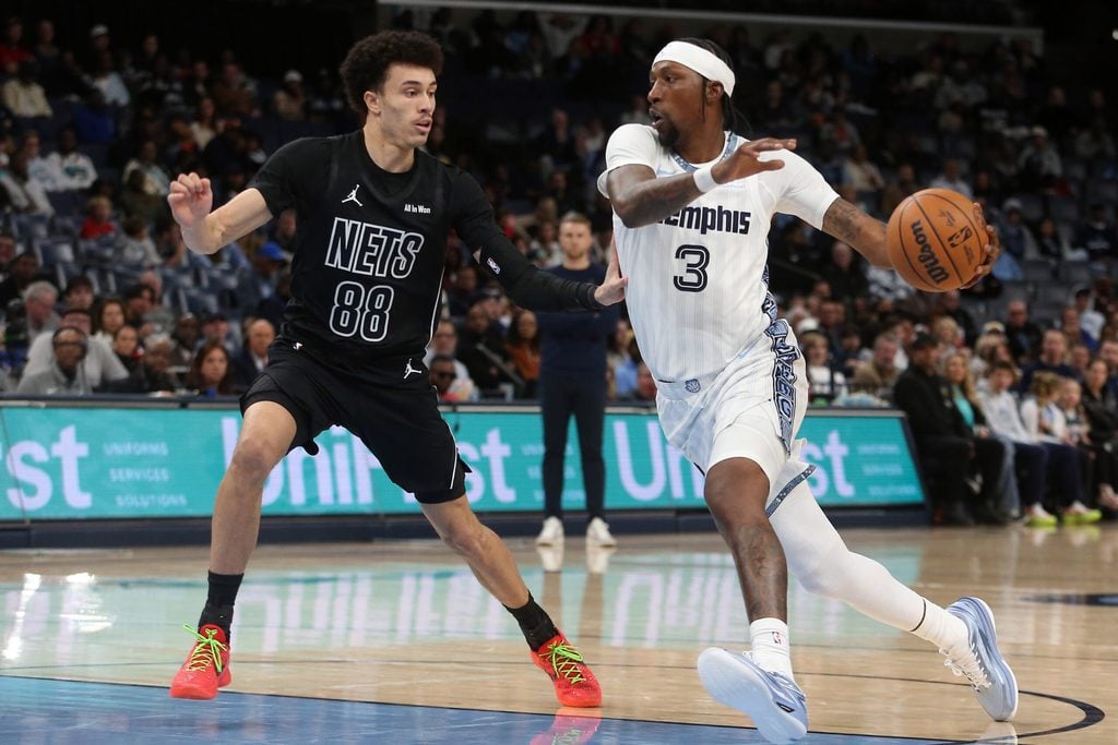 Jan 11, 2026; Memphis, Tennessee, USA; Memphis Grizzlies forward Kentavious Caldwell-Pope (3) drives to the basket as Brooklyn Nets guard Nolan Traore (88) defends during the third quarter at FedExForum. Mandatory Credit: Petre Thomas-Imagn Images