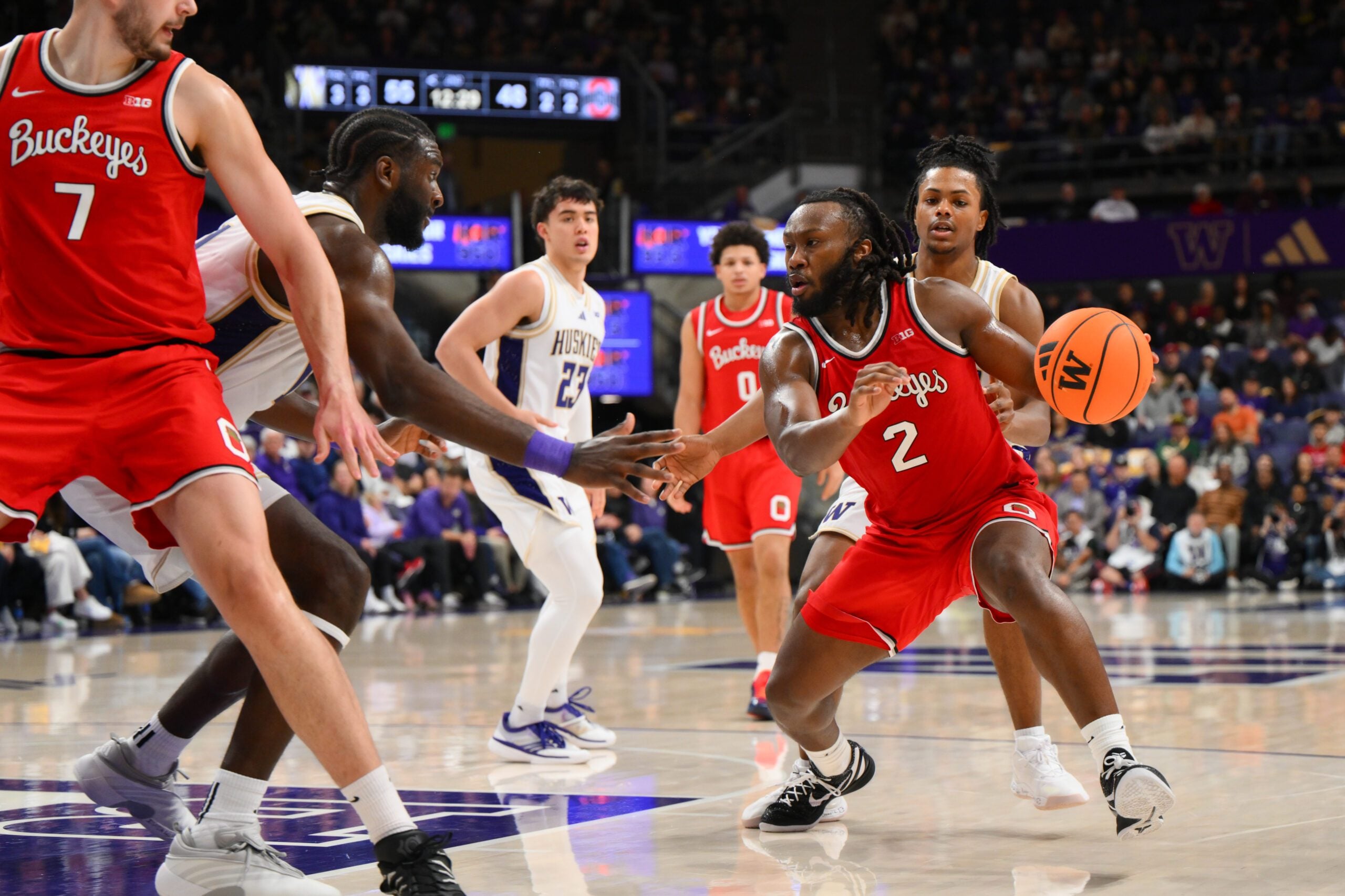 Jan 11, 2026; Seattle, Washington, USA; Ohio State Buckeyes guard Bruce Thornton (2) dribbles the ball while guarded by Washington Huskies center Franck Kepnang (11) during the second half at Alaska Airlines Arena at Hec Edmundson Pavilion. Mandatory Credit: Steven Bisig-Imagn Images