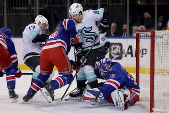 Jan 12, 2026; New York, New York, USA; New York Rangers goaltender Jonathan Quick (32) and left wing Brennan Othmann (78) fight for the puck against Seattle Kraken centers Jaden Schwartz (17) and Frederick Gaudreau (89) during the first period at Madison Square Garden. Mandatory Credit: Brad Penner-Imagn Images