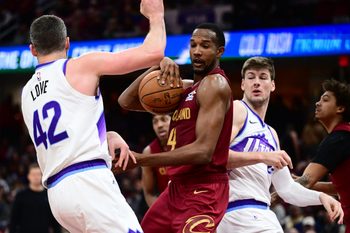 Jan 12, 2026; Cleveland, Ohio, USA; Cleveland Cavaliers center Evan Mobley (4) goes for a rebound against Utah Jazz forward Kevin Love (42) and Utah Jazz forward Kyle Filipowski (22) during the second half at Rocket Arena. Mandatory Credit: Ken Blaze-Imagn Images