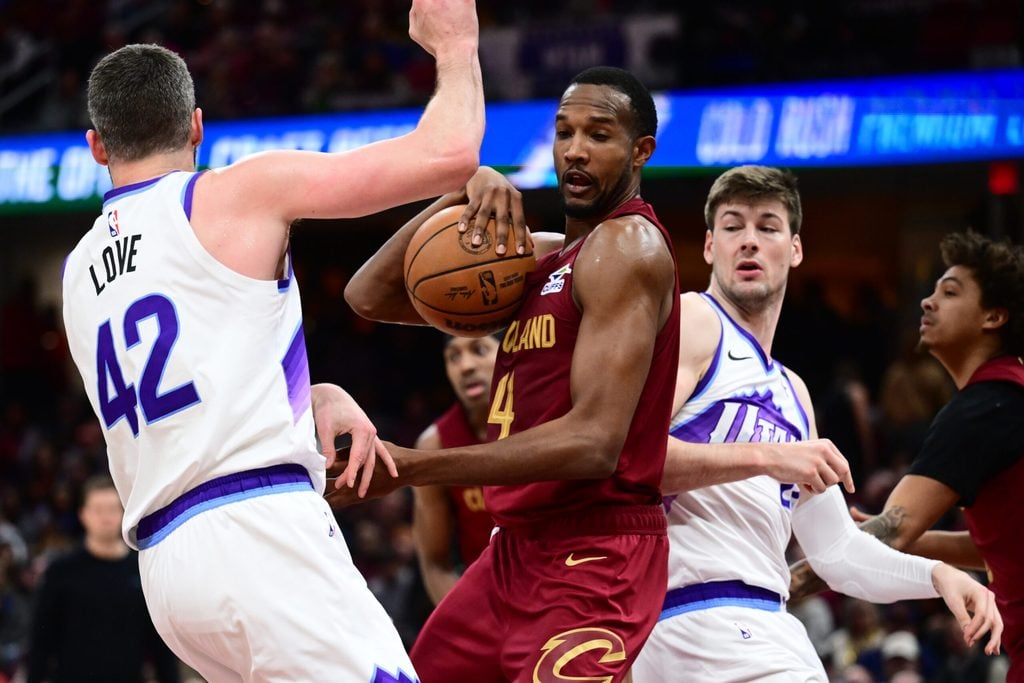 Jan 12, 2026; Cleveland, Ohio, USA; Cleveland Cavaliers center Evan Mobley (4) goes for a rebound against Utah Jazz forward Kevin Love (42) and Utah Jazz forward Kyle Filipowski (22) during the second half at Rocket Arena. Mandatory Credit: Ken Blaze-Imagn Images