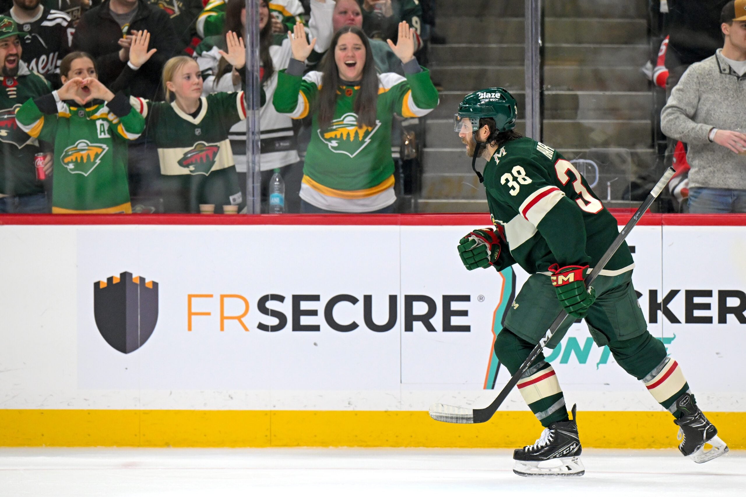 Jan 12, 2026; Saint Paul, Minnesota, USA;  Minnesota Wild forward Ryan Hartman (38) heads to the bench after celebrating his goal against the New Jersey Devils during the second period at Grand Casino Arena. Mandatory Credit: Nick Wosika-Imagn Images