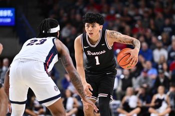Jan 8, 2026; Spokane, Washington, USA; Santa Clara Broncos guard Christian Hammond (1) controls the ball against Gonzaga Bulldogs guard Adam Miller (23) in the second half at McCarthey Athletic Center. Mandatory Credit: James Snook-Imagn Images
