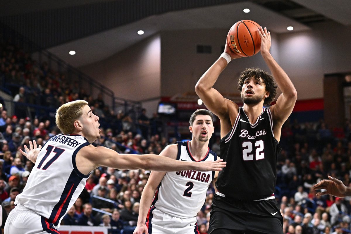 Jan 8, 2026; Spokane, Washington, USA; Santa Clara Broncos forward Allen Graves (22) shoots the ball against Gonzaga Bulldogs guard Mario Saint-Supery (17) in the second half at McCarthey Athletic Center. Mandatory Credit: James Snook-Imagn Images