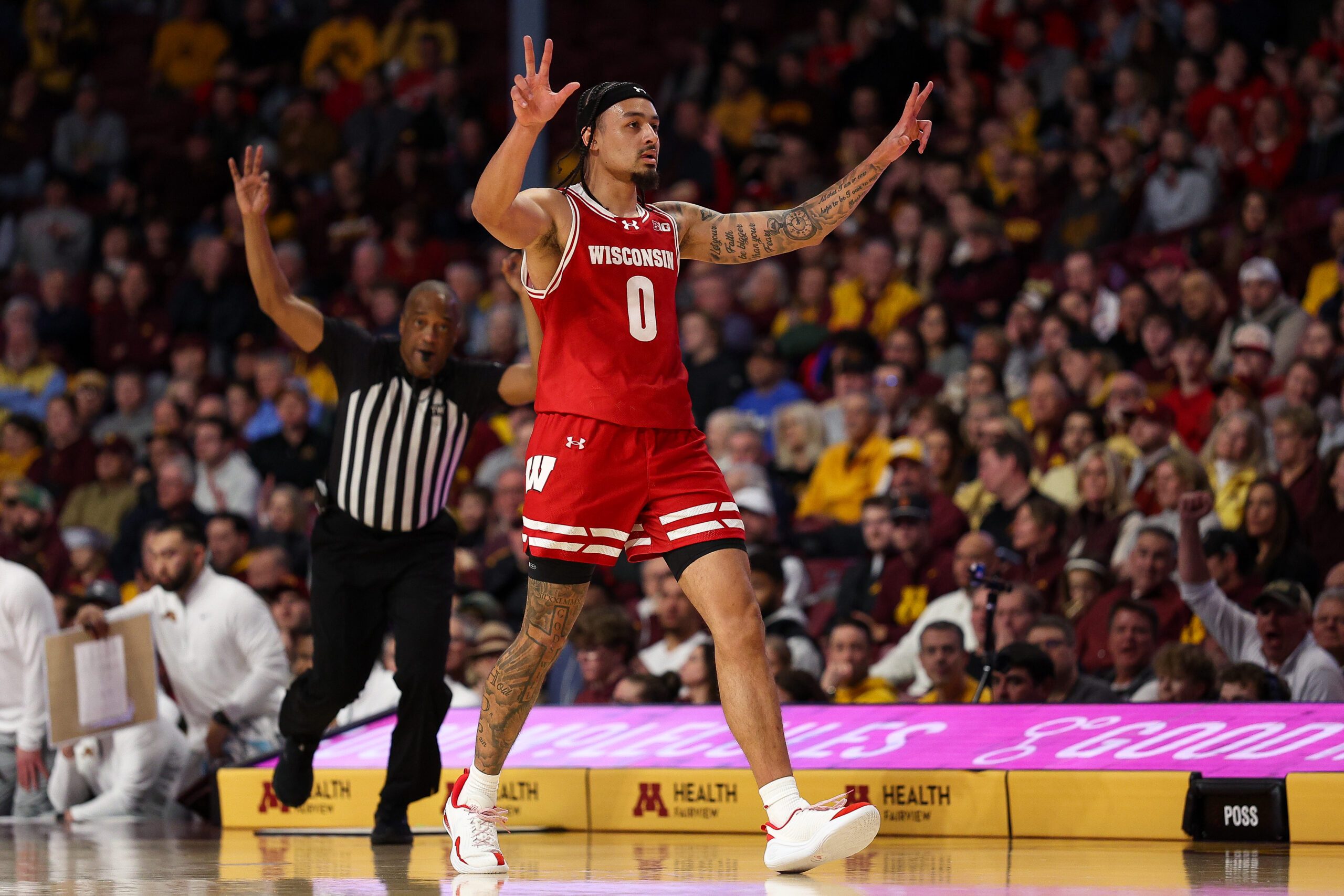 Jan 13, 2026; Minneapolis, Minnesota, USA; Wisconsin Badgers guard Braeden Carrington (0) celebrates his three-point basket against the Minnesota Golden Gophers during the first half at Williams Arena. Mandatory Credit: Matt Krohn-Imagn Images