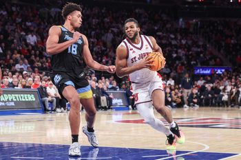 Jan 13, 2026; New York, New York, USA;  St. John's Red Storm forward Zuby Ejiofor (24) drives past Marquette Golden Eagles forward Caedin Hamilton (18) in the second half at Madison Square Garden Mandatory Credit: Wendell Cruz-Imagn Images