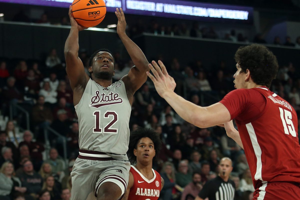 Jan 13, 2026; Starkville, Mississippi, USA; Mississippi State Bulldogs guard Josh Hubbard (12) shoots as Alabama Crimson Tide center Noah Williamson (15) defends during the first half at Humphrey Coliseum. Mandatory Credit: Petre Thomas-Imagn Images