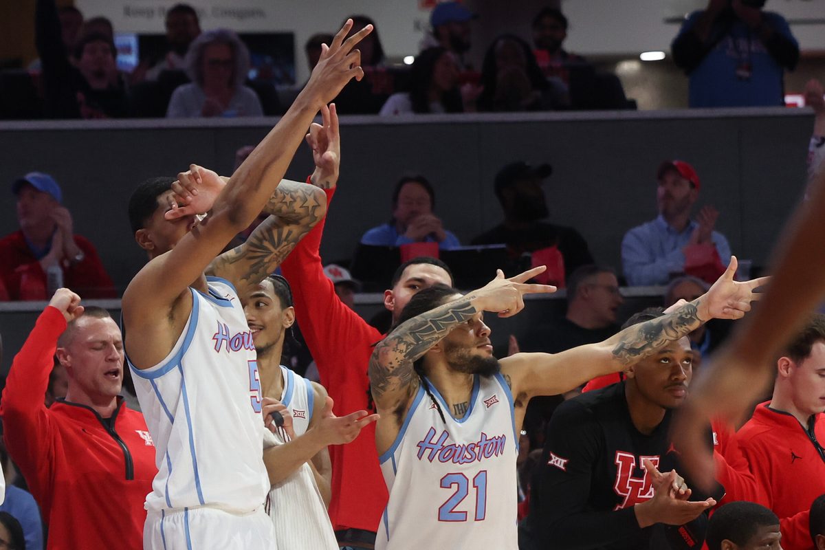 Jan 13, 2026; Houston, Texas, USA; Houston Cougars center Chris Cenac Jr. (5) and Houston Cougars guard Emanuel Sharp (21) celebrates a Cougars three point basket against the West Virginia Mountaineers  in the second half at Fertitta Center. Mandatory Credit: Thomas Shea-Imagn Images