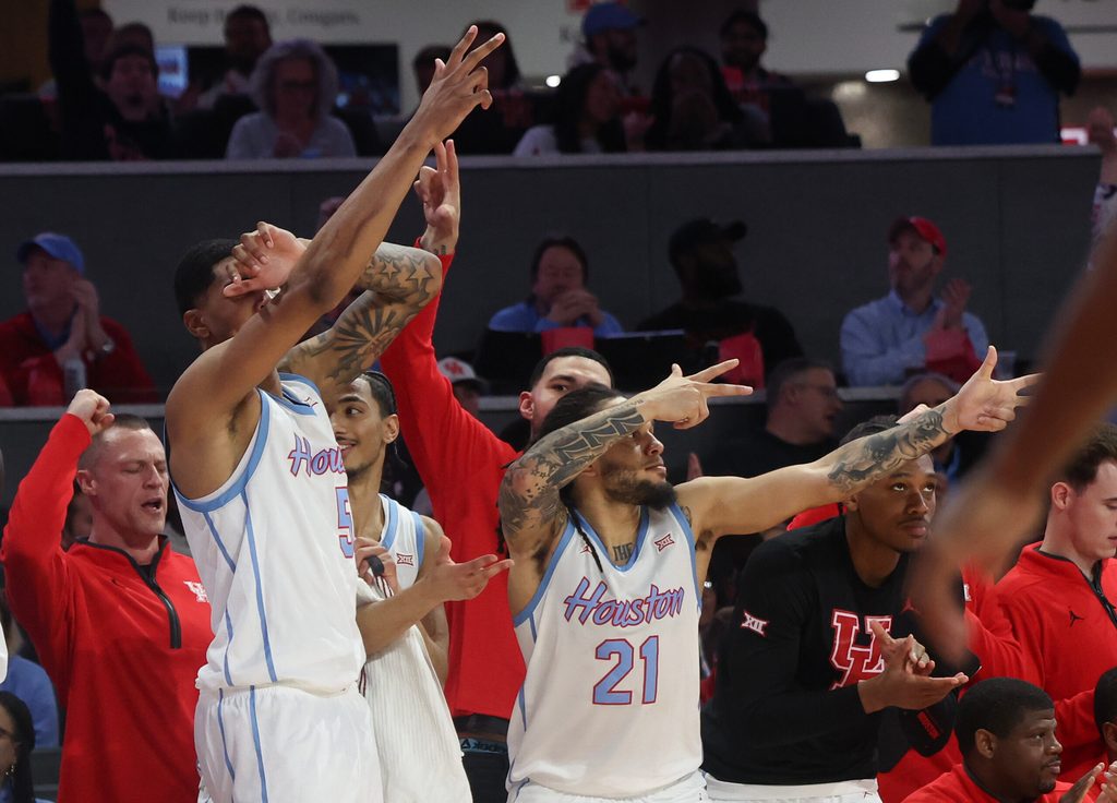 Jan 13, 2026; Houston, Texas, USA; Houston Cougars center Chris Cenac Jr. (5) and Houston Cougars guard Emanuel Sharp (21) celebrates a Cougars three point basket against the West Virginia Mountaineers in the second half at Fertitta Center. Mandatory Credit: Thomas Shea-Imagn Images