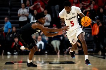 Colorado Buffaloes guard Isaiah Johnson (2) fouls Cincinnati Bearcats guard Sencire Harris (5) in the second half of the NCAA Basketball game at Fifth Third Arena in Cincinnati on Jan. 14, 2026.