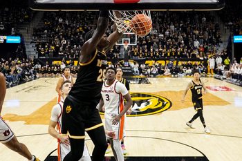 Jan 14, 2026; Columbia, Missouri, USA; Missouri Tigers guard Mark Mitchell (25) dunks he ball as Auburn Tigers forward Keshawn Murphy (3) looks on during the second half of the game at Mizzou Arena. Mandatory Credit: Denny Medley-Imagn Images