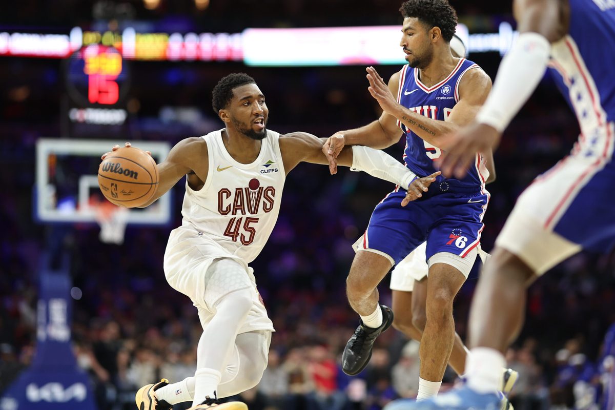 Jan 14, 2026; Philadelphia, Pennsylvania, USA; Cleveland Cavaliers guard Donovan Mitchell (45) drives against Philadelphia 76ers guard Quentin Grimes (5) during the third quarter at Xfinity Mobile Arena. Mandatory Credit: Bill Streicher-Imagn Images