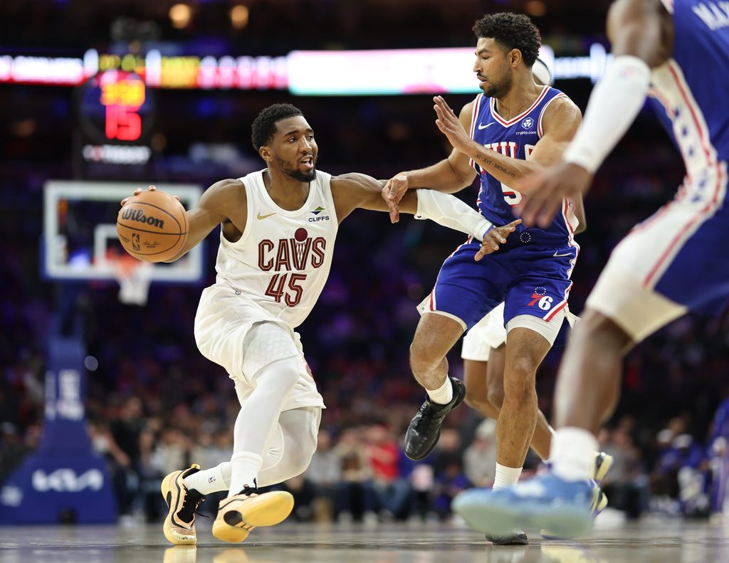 Jan 14, 2026; Philadelphia, Pennsylvania, USA; Cleveland Cavaliers guard Donovan Mitchell (45) drives against Philadelphia 76ers guard Quentin Grimes (5) during the third quarter at Xfinity Mobile Arena. Mandatory Credit: Bill Streicher-Imagn Images