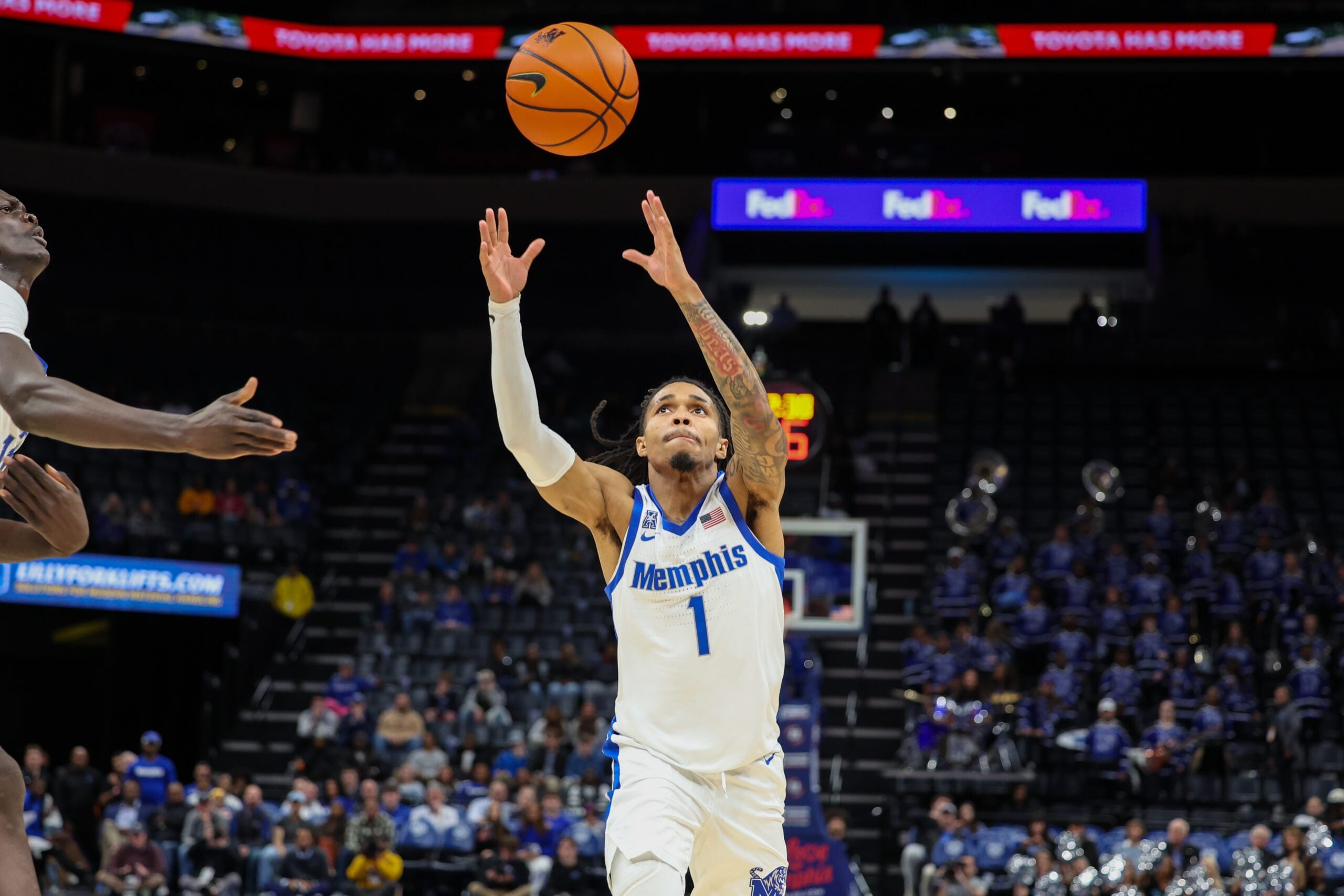 Jan 14, 2026; Memphis, Tennessee, USA; Memphis Tigers guard Dug McDaniel (1) reaches for a rebound during the second half against the Temple Owls at FedExForum. Mandatory Credit: Wesley Hale-Imagn Images