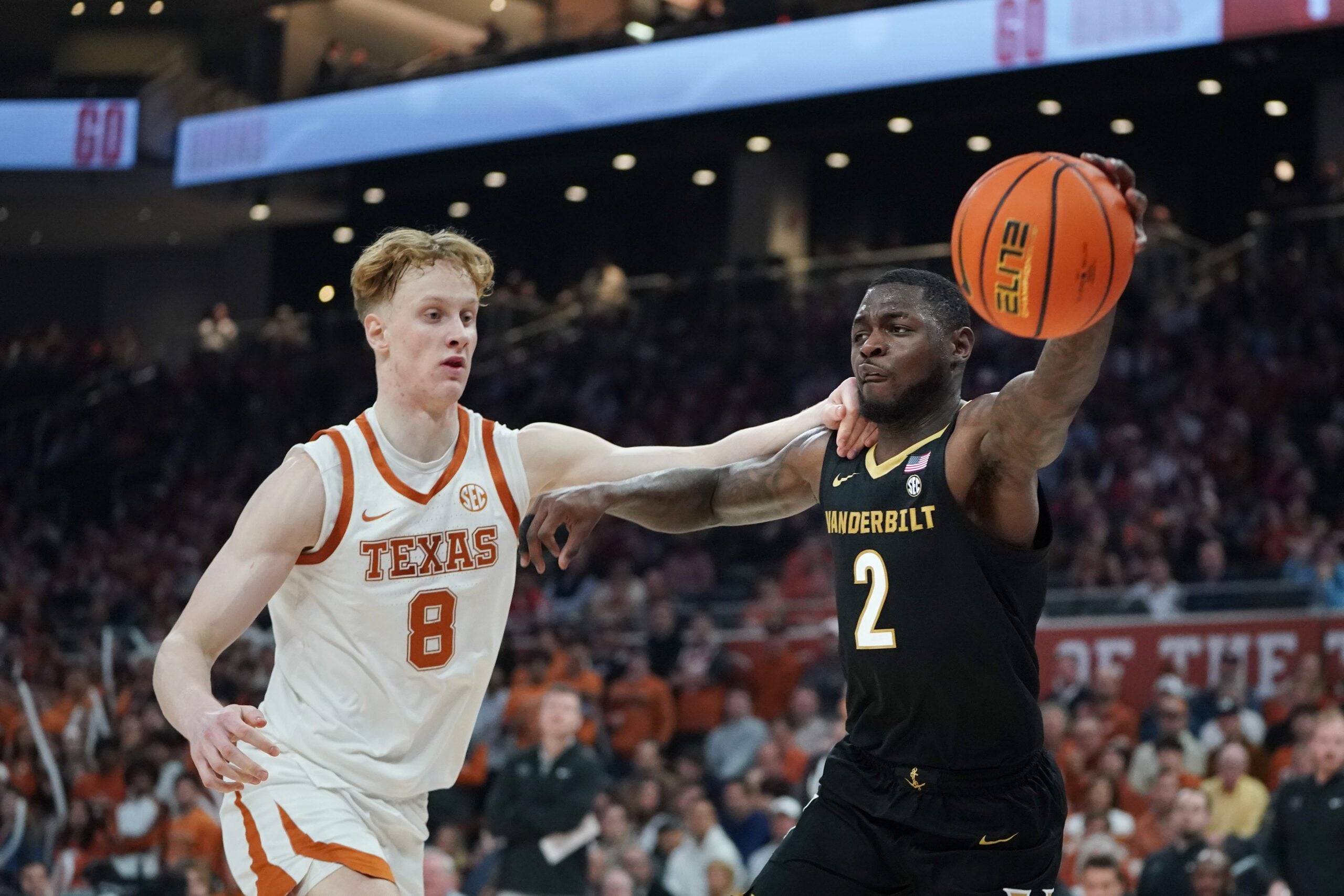 Jan 14, 2026; Austin, Texas, USA; Vanderbilt Commodores guard Duke Miles (2) passes against Texas Longhorns center Matas Vokietaitis (8) during the first half at Moody Center. Mandatory Credit: Dustin Safranek-Imagn Images