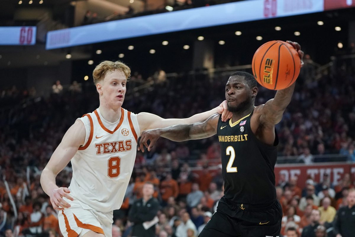 Jan 14, 2026; Austin, Texas, USA; Vanderbilt Commodores guard Duke Miles (2) passes against Texas Longhorns center Matas Vokietaitis (8) during the first half at Moody Center. Mandatory Credit: Dustin Safranek-Imagn Images