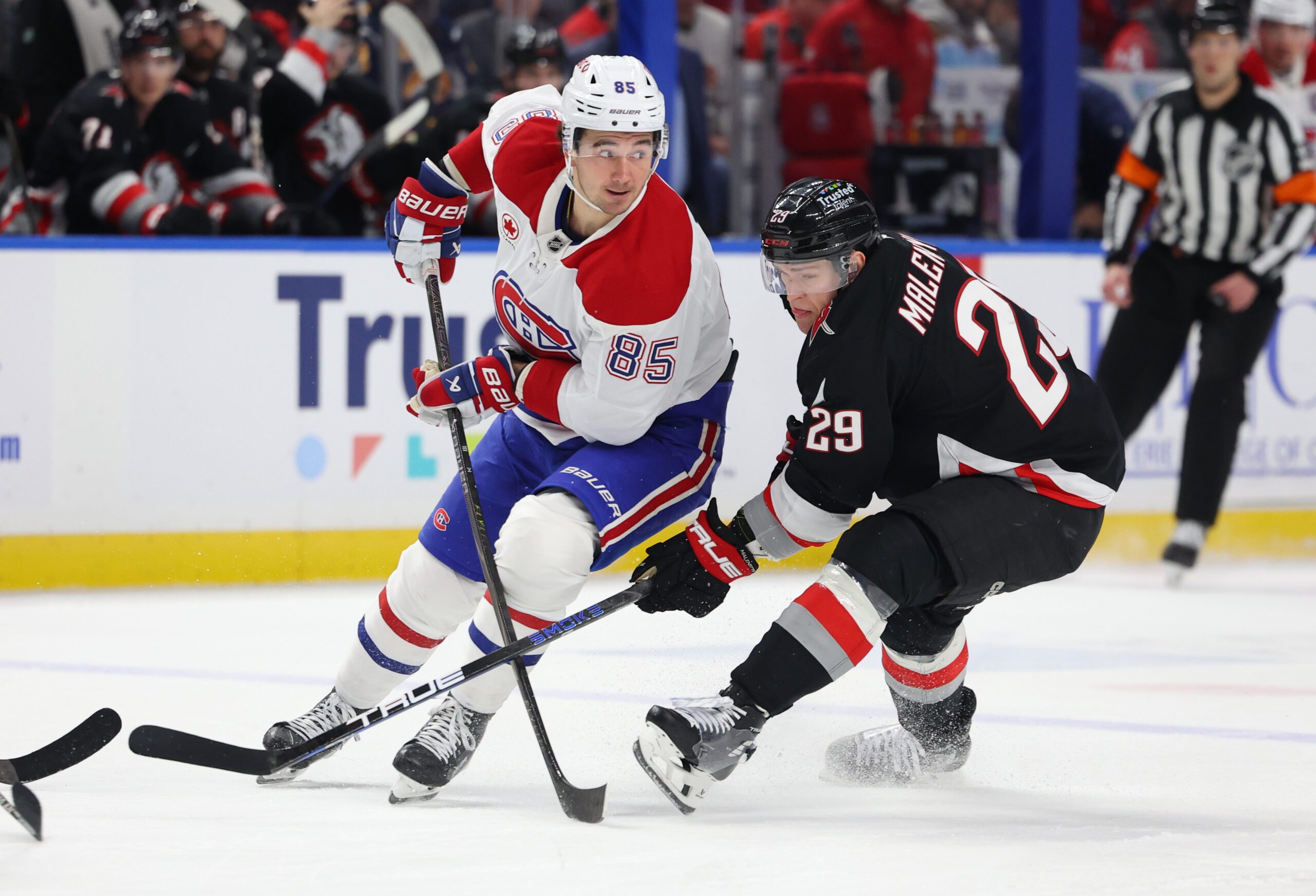 Jan 15, 2026; Buffalo, New York, USA;  Montréal Canadiens left wing Alexandre Texier (85) makes a pass as Buffalo Sabres left wing Beck Malenstyn (29) defends during the first period at KeyBank Center. Mandatory Credit: Timothy T. Ludwig-Imagn Images