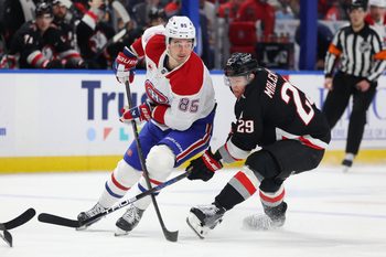 Jan 15, 2026; Buffalo, New York, USA;  Montréal Canadiens left wing Alexandre Texier (85) makes a pass as Buffalo Sabres left wing Beck Malenstyn (29) defends during the first period at KeyBank Center. Mandatory Credit: Timothy T. Ludwig-Imagn Images