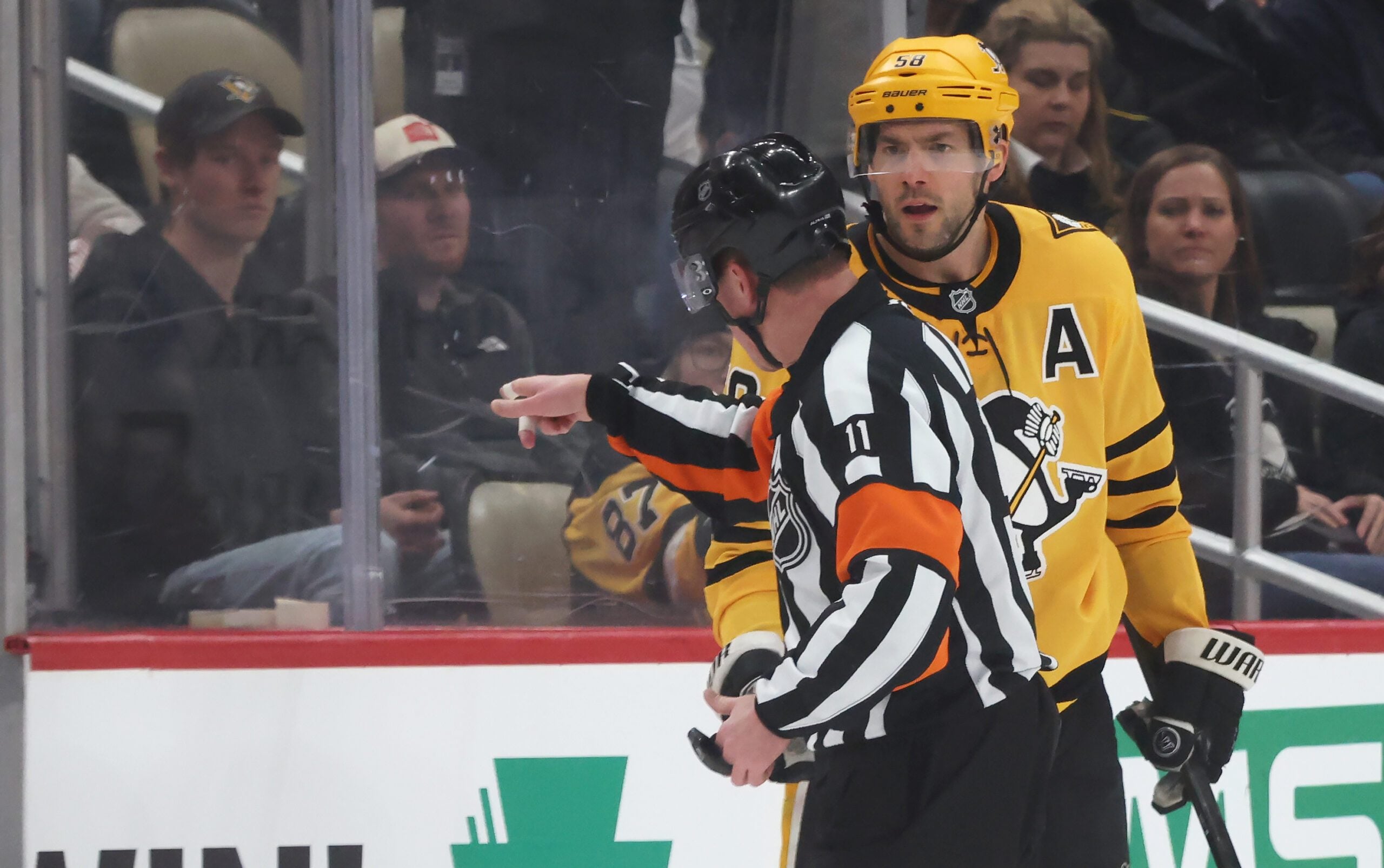 Jan 15, 2026; Pittsburgh, Pennsylvania, USA;  Pittsburgh Penguins defenseman Kris Letang (58) reacts a to referee Kelly Sutherland (11) after being penalized for boarding against the Philadelphia Flyers during the third period at PPG Paints Arena. Mandatory Credit: Charles LeClaire-Imagn Images