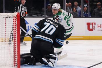 Jan 15, 2026; Salt Lake City, Utah, USA; Utah Mammoth goaltender Karel Vejmelka (70) blocks a shot by Dallas Stars center Roope Hintz (24) during the third period at Delta Center. Mandatory Credit: Rob Gray-Imagn Images