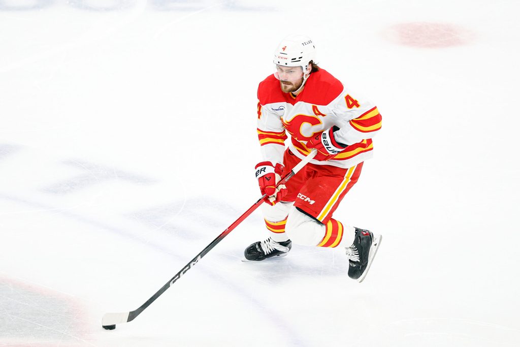 Jan 15, 2026; Chicago, Illinois, USA; Calgary Flames defenseman Rasmus Andersson (4) controls the puck against the Chicago Blackhawks during the second period at United Center. Mandatory Credit: Kamil Krzaczynski-Imagn Images