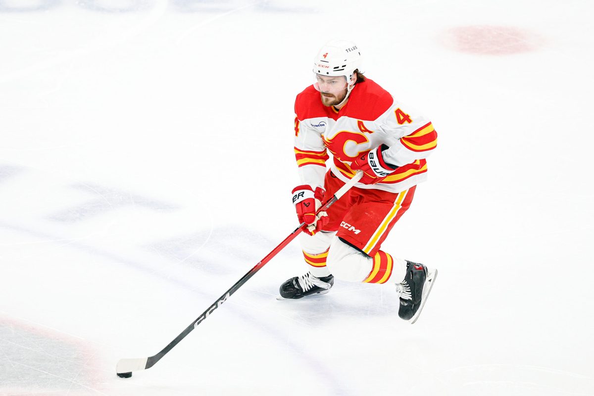 Jan 15, 2026; Chicago, Illinois, USA; Calgary Flames defenseman Rasmus Andersson (4) controls the puck against the Chicago Blackhawks during the second period at United Center. Mandatory Credit: Kamil Krzaczynski-Imagn Images