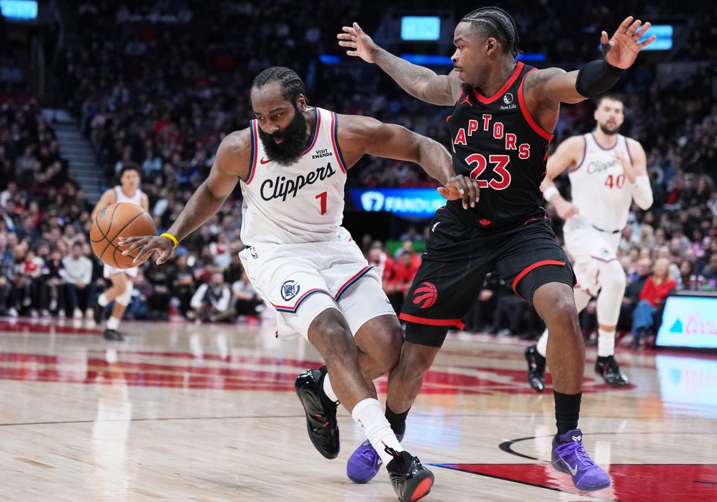 Jan 16, 2026; Toronto, Ontario, CAN; LA Clippers guard James Harden (1) controls the ball as Toronto Raptors guard Jamal Shead (23) tries to defend during the fourth quarter at Scotiabank Arena. Mandatory Credit: Nick Turchiaro-Imagn Images