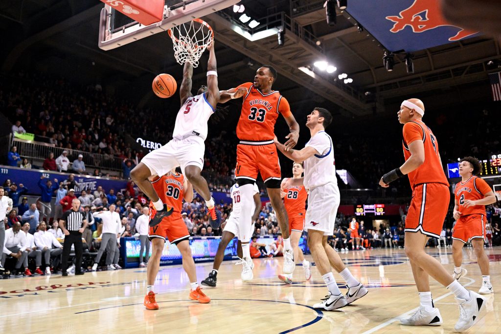 Jan 17, 2026; Dallas, Texas, USA; SMU Mustangs guard Jaron Pierre Jr. (5) dunks the ball past Virginia Cavaliers center Ugonna Onyenso (33) during the second half at Moody Coliseum. Mandatory Credit: Jerome Miron-Imagn Images