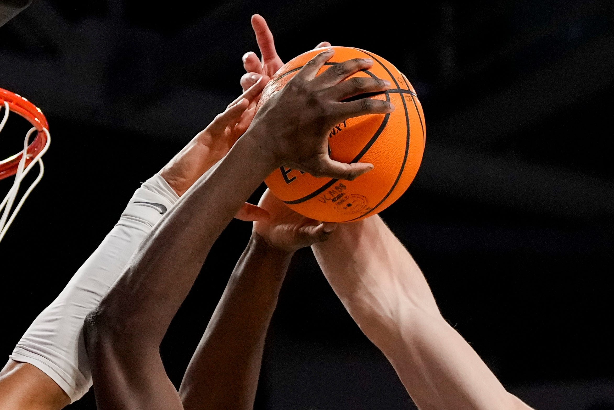 Cincinnati Bearcats forward Tyler McKinley (24) is blocked by Iowa State Cyclones forward Joshua Jefferson (5) and forward Blake Buchanan (23) in the first half of the NCAA Big 12 basketball game between the Cincinnati Bearcats and the Iowa State Cyclones at Fifth Third Stadium in Cincinnati on Saturday, Jan. 17, 2026.