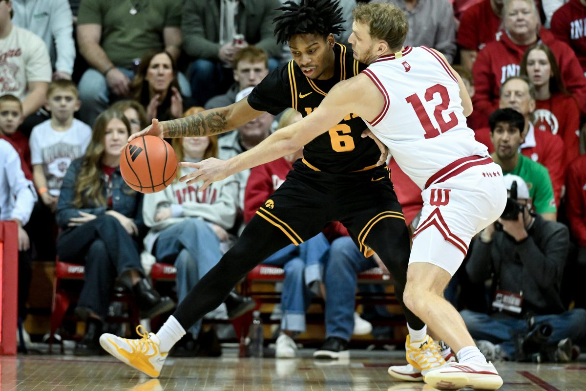 Jan 17, 2026; Bloomington, Indiana, USA; Indiana Hoosiers forward Tucker DeVries (12) knocks the ball away from Iowa Hawkeyes guard Tavion Banks (6) during the first half at Simon Skjodt Assembly Hall. Mandatory Credit: Robert Goddin-Imagn Images