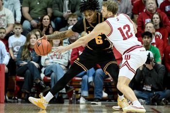 Jan 17, 2026; Bloomington, Indiana, USA; Indiana Hoosiers forward Tucker DeVries (12) knocks the ball away from Iowa Hawkeyes guard Tavion Banks (6) during the first half at Simon Skjodt Assembly Hall. Mandatory Credit: Robert Goddin-Imagn Images