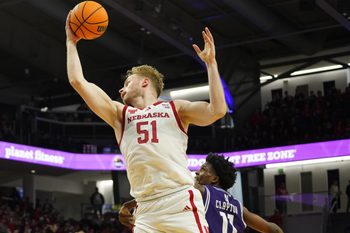 Jan 17, 2026; Evanston, Illinois, USA; Nebraska Cornhuskers forward Rienk Mast (51) grabs a rebound over Northwestern Wildcats guard Jordan Clayton (11) during the first half at Welsh-Ryan Arena. Mandatory Credit: David Banks-Imagn Images