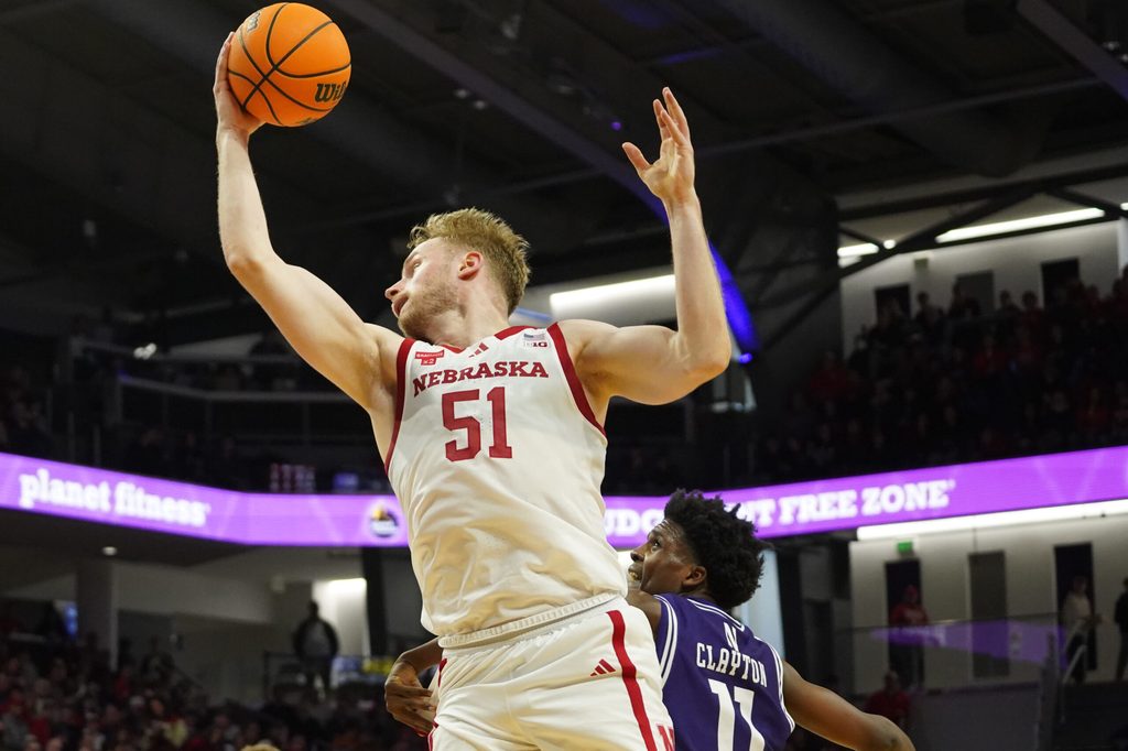 Jan 17, 2026; Evanston, Illinois, USA; Nebraska Cornhuskers forward Rienk Mast (51) grabs a rebound over Northwestern Wildcats guard Jordan Clayton (11) during the first half at Welsh-Ryan Arena. Mandatory Credit: David Banks-Imagn Images