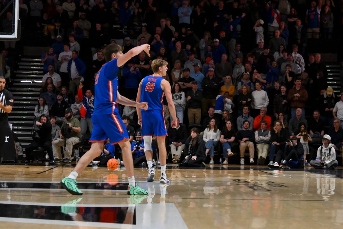 Jan 17, 2026; Nashville, Tennessee, USA; Florida Gators forward Alex Condon (21) and forward Thomas Haugh (10) taunt the Vanderbilt Commodores student section during the second half at Memorial Gymnasium. Mandatory Credit: Steve Roberts-Imagn Images