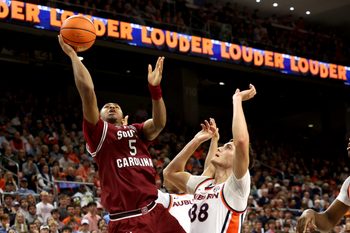 Jan 17, 2026; Auburn, Alabama, USA; South Carolina Gamecocks guard Meechie Johnson (5) gets past Auburn Tigers forward Filip Jovic (38) for a shot during the first half at Neville Arena. Mandatory Credit: John Reed-Imagn Images
