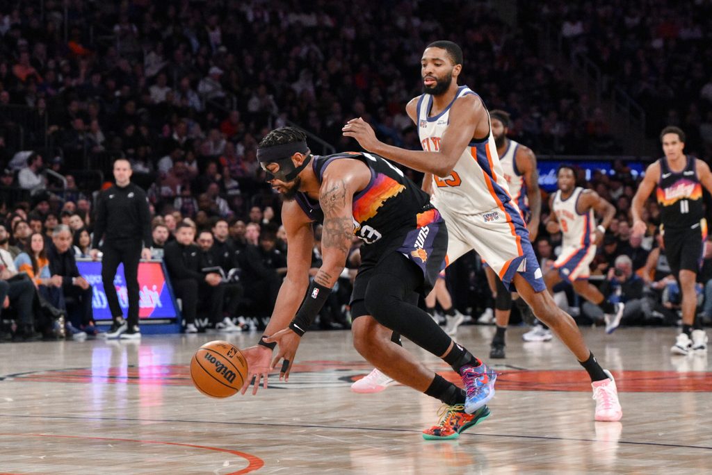 Jan 17, 2026; New York, New York, USA; Phoenix Suns guard Jordan Goodwin (23) gathers a loose ball as New York Knicks guard Mikal Bridges (25) defends during the second half at Madison Square Garden. Mandatory Credit: John Jones-Imagn Images
