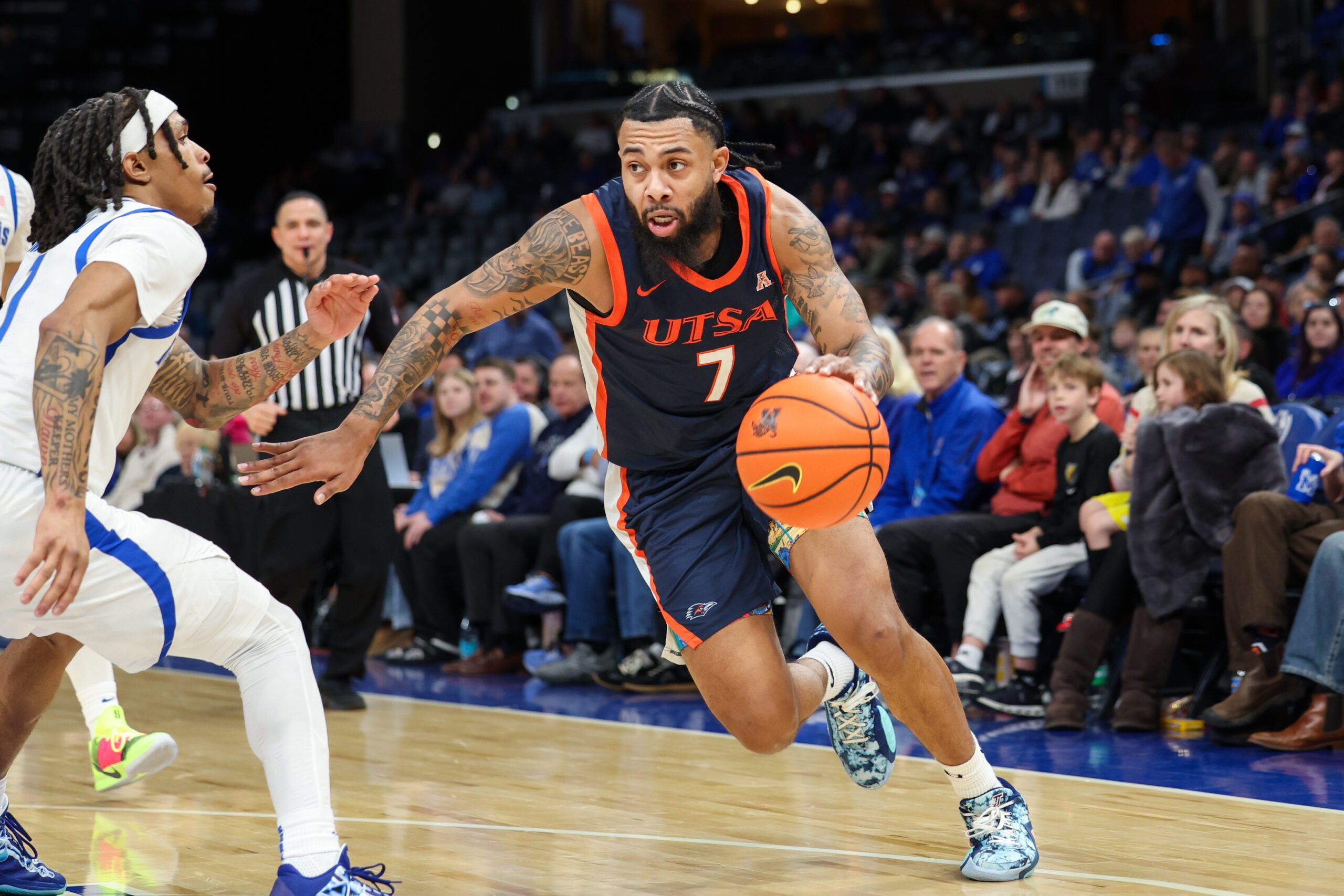 Jan 18, 2026; Memphis, Tennessee, USA; UTSA Roadrunners guard Jamir Simpson (7) drives against Memphis Tigers guard Dug McDaniel (1) during the second half at FedExForum. Mandatory Credit: Wesley Hale-Imagn Images