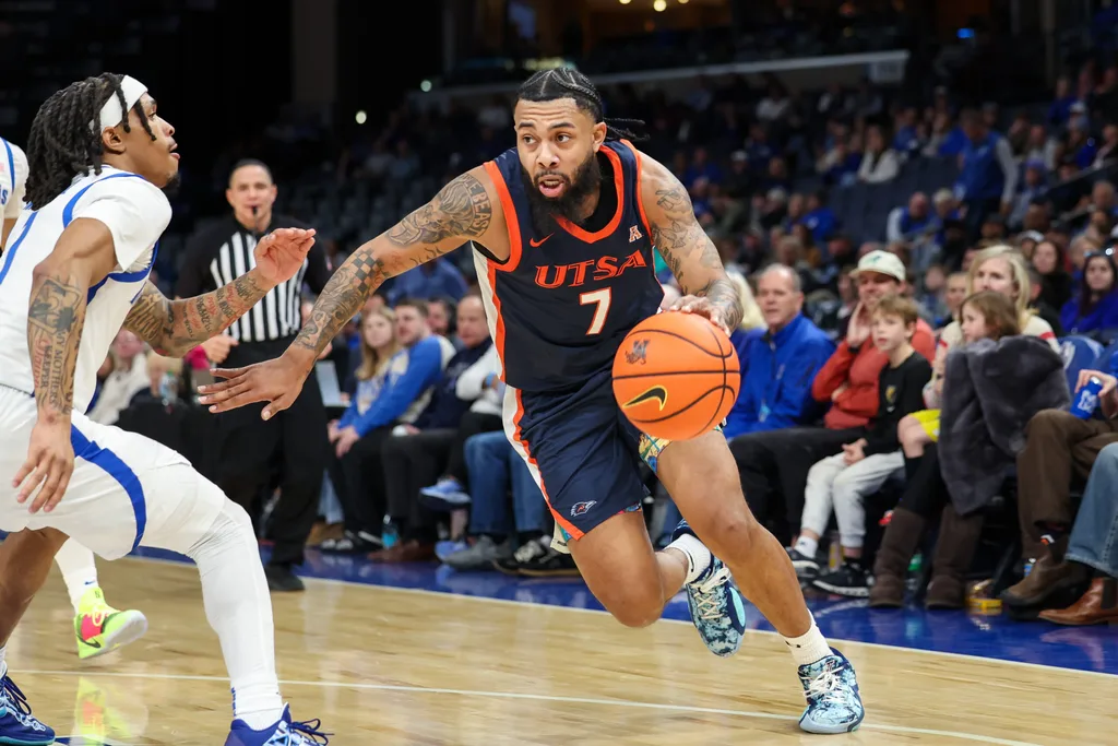 Jan 18, 2026; Memphis, Tennessee, USA; UTSA Roadrunners guard Jamir Simpson (7) drives against Memphis Tigers guard Dug McDaniel (1) during the second half at FedExForum. Mandatory Credit: Wesley Hale-Imagn Images