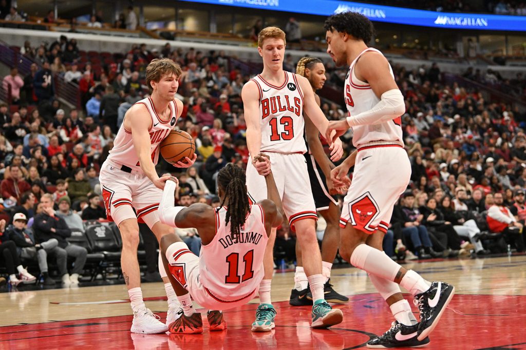 Jan 18, 2026; Chicago, Illinois, USA; Chicago Bulls forward Matas Buzelis (14) and guard Kevin Huerter (13) help up guard Ayo Dosunmu (11) against the Brooklyn Nets during the second half at United Center. Mandatory Credit: Patrick Gorski-Imagn Images