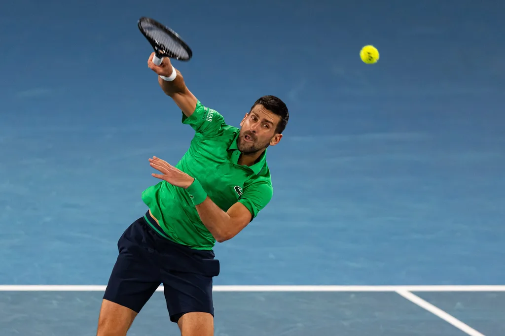 Jan 19, 2026; Melbourne, Victoria, Australia; Novak Djokovic of Serbia in action against Pedro Martinez of Spain in the first round of the men’s singles at the Australian Open at Rod Laver Arena in Melbourne Park. Mandatory Credit: Mike Frey-Imagn Images