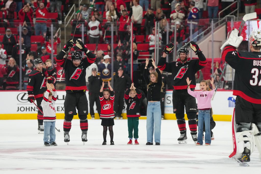 Jan 19, 2026; Raleigh, North Carolina, USA; Carolina Hurricanes center Jordan Staal (11) and left wing William Carrier (28) celebrates their victory with the kids against the Buffalo Sabres at Lenovo Center. Mandatory Credit: James Guillory-Imagn Images