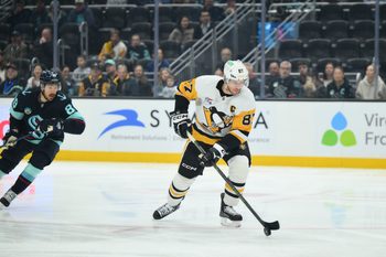 Jan 19, 2026; Seattle, Washington, USA; Pittsburgh Penguins center Sidney Crosby (87) advances the puck against the Seattle Kraken during the first period at Climate Pledge Arena. Mandatory Credit: Steven Bisig-Imagn Images