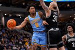 Jan 19, 2026; Milwaukee, Wisconsin, USA;  Marquette Golden Eagles guard Nigel James Jr. (0) passes the ball around Providence Friars forward Duncan Powell (31) during the second half at Fiserv Forum. Mandatory Credit: Jeff Hanisch-Imagn Images