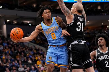 Jan 19, 2026; Milwaukee, Wisconsin, USA;  Marquette Golden Eagles guard Nigel James Jr. (0) passes the ball around Providence Friars forward Duncan Powell (31) during the second half at Fiserv Forum. Mandatory Credit: Jeff Hanisch-Imagn Images