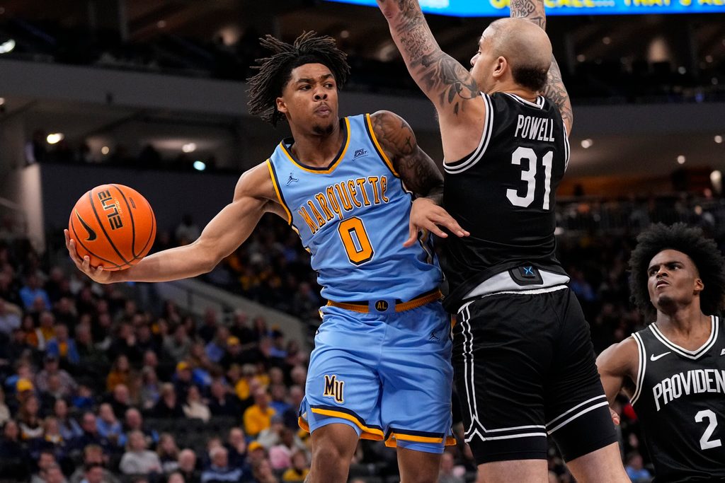 Jan 19, 2026; Milwaukee, Wisconsin, USA; Marquette Golden Eagles guard Nigel James Jr. (0) passes the ball around Providence Friars forward Duncan Powell (31) during the second half at Fiserv Forum. Mandatory Credit: Jeff Hanisch-Imagn Images