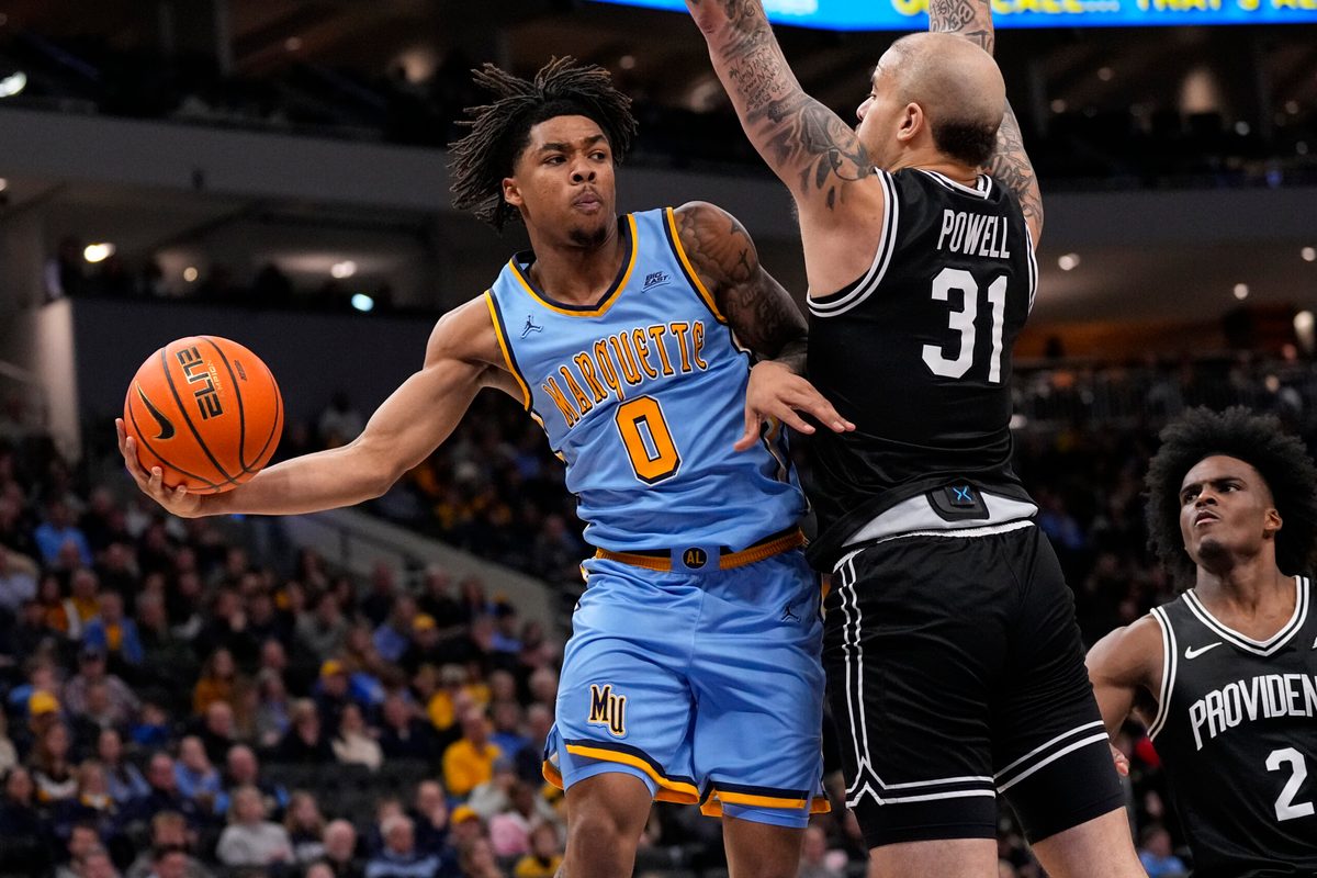 Jan 19, 2026; Milwaukee, Wisconsin, USA; Marquette Golden Eagles guard Nigel James Jr. (0) passes the ball around Providence Friars forward Duncan Powell (31) during the second half at Fiserv Forum. Mandatory Credit: Jeff Hanisch-Imagn Images