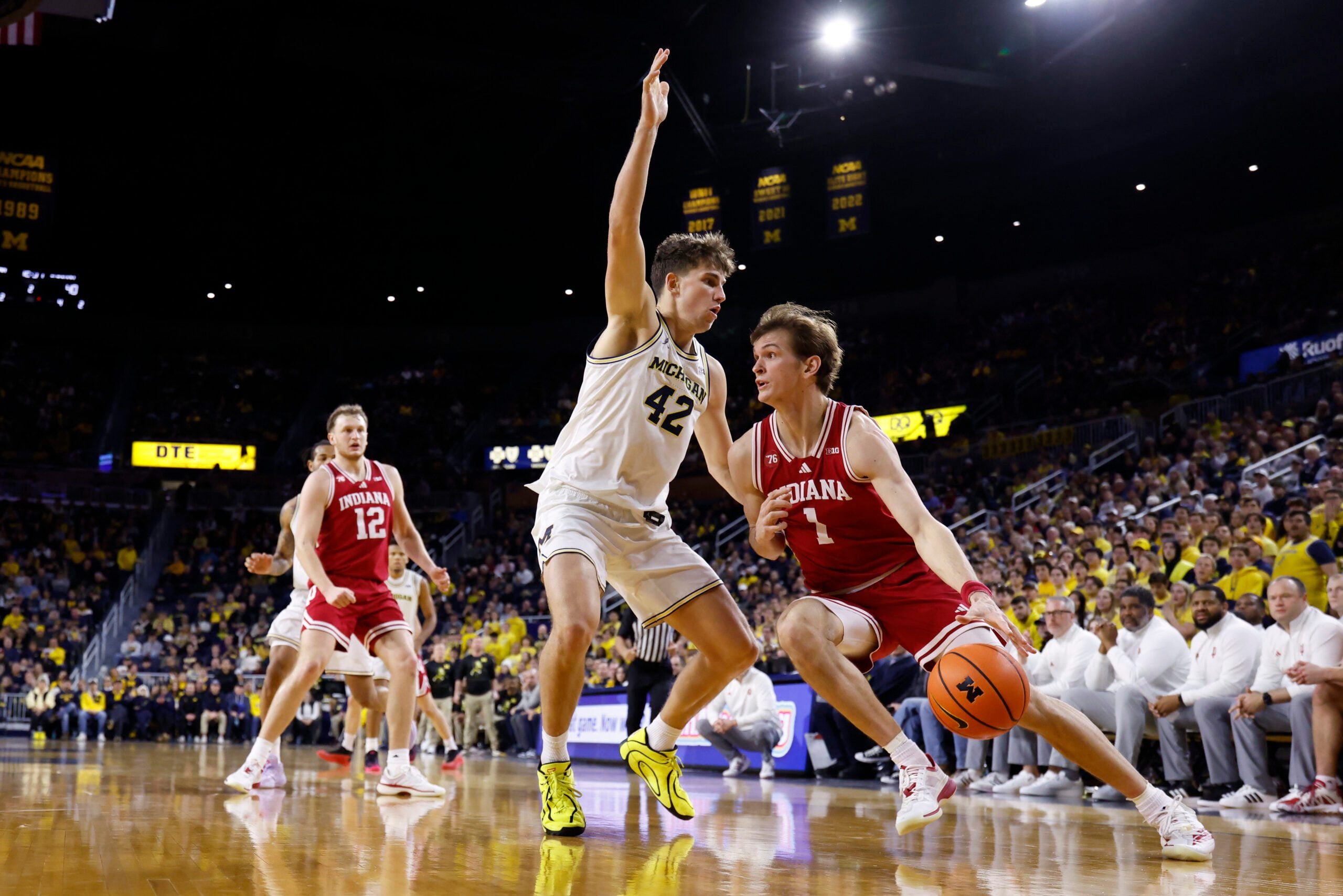 Jan 20, 2026; Ann Arbor, Michigan, USA;  Indiana Hoosiers forward Reed Bailey (1) dribbles defended by Michigan Wolverines forward Will Tschetter (42) in the second half at Crisler Center. Mandatory Credit: Rick Osentoski-Imagn Images