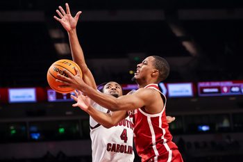 Jan 20, 2026; Columbia, South Carolina, USA; Oklahoma Sooners guard Xzayvier Brown (1) drives past South Carolina Gamecocks guard Kobe Knox (4) in the second half at Colonial Life Arena. Mandatory Credit: Jeff Blake-Imagn Images